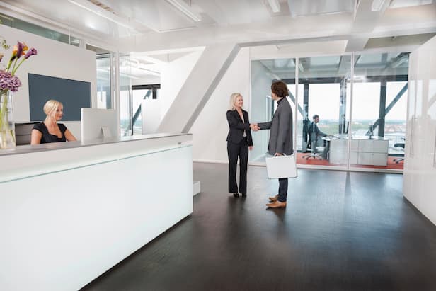 woman-shaking-hands-with-visitor-at-reception-2025-04-04-15-43-13-utc.jpg